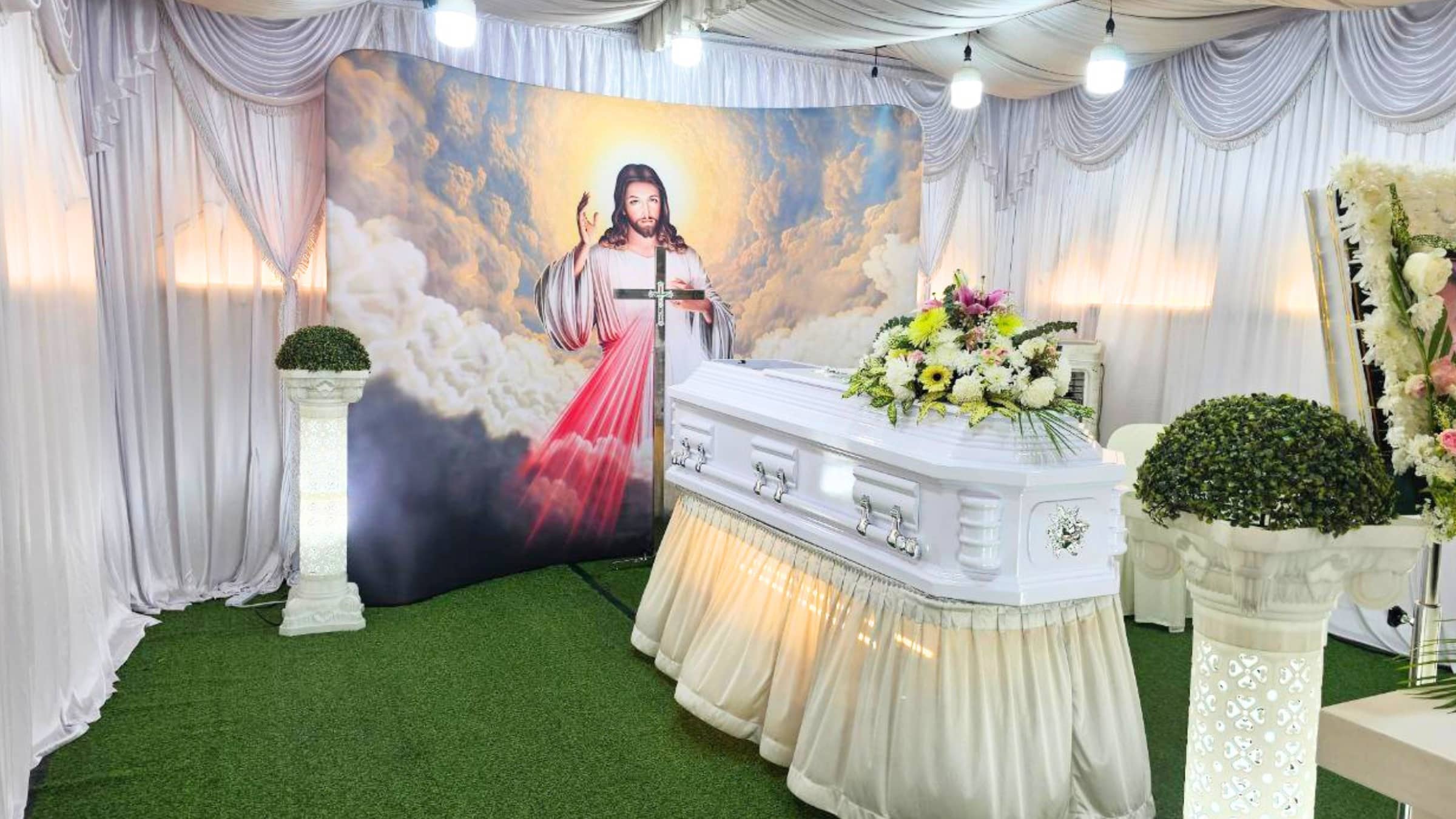 Catholic funeral wake setup with rosary, crucifix and candles arranged by Farewell Funerals in Singapore